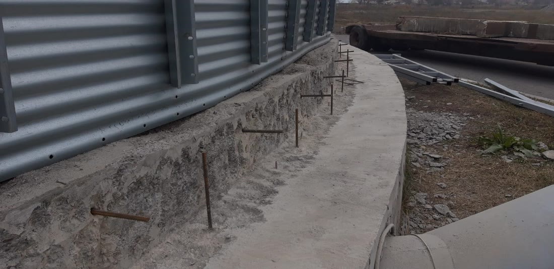 The base of a steel silo with the perimeter concrete ring under construction
