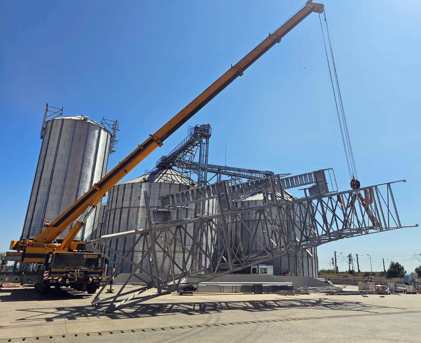 A steel structure lifted by crane on site